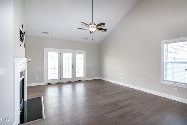 3206 Dandelion Dr, Grimesland, NC 27837 - unfurnished living room with ceiling fan, plenty of natural light, dark wood-style floors, high vaulted ceiling, and a fireplace