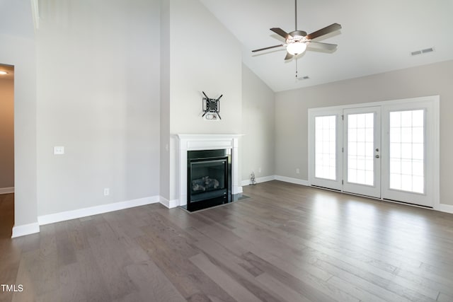 3206 Dandelion Dr, Grimesland, NC 27837 - unfurnished living room featuring a ceiling fan, high vaulted ceiling, dark wood-style flooring, and a fireplace with flush hearth