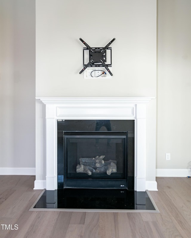 3206 Dandelion Dr, Grimesland, NC 27837 - detailed view of a glass covered fireplace and wood finished floors