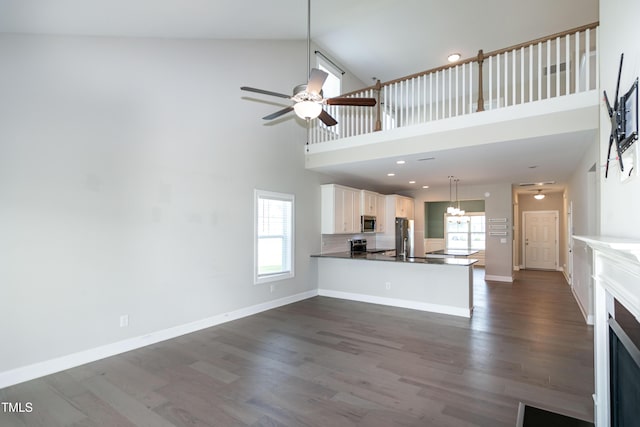 3206 Dandelion Dr, Grimesland, NC 27837 - unfurnished living room with a high ceiling, ceiling fan, dark wood finished floors, and recessed lighting