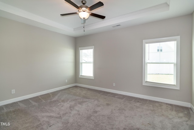 3206 Dandelion Dr, Grimesland, NC 27837 - spare room featuring a tray ceiling, ornamental molding, carpet, and ceiling fan