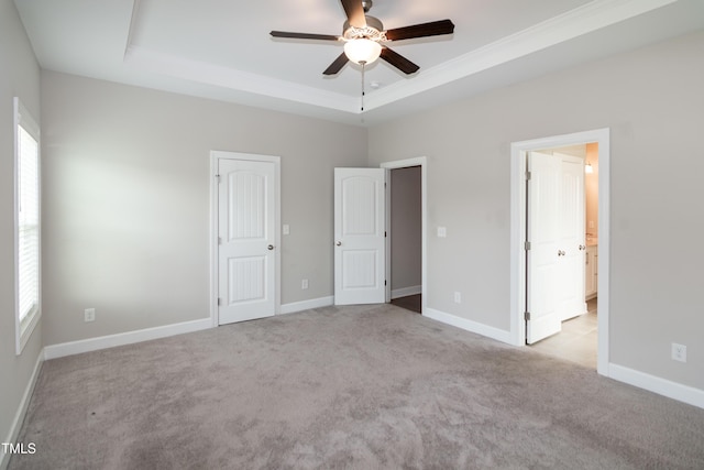 3206 Dandelion Dr, Grimesland, NC 27837 - unfurnished bedroom featuring multiple windows, a tray ceiling, carpet, and crown molding