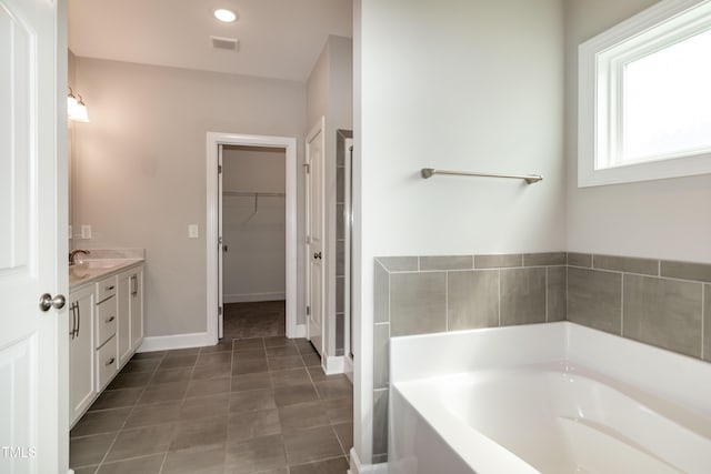 3206 Dandelion Dr, Grimesland, NC 27837 - full bathroom with a garden tub, vanity, a spacious closet, and tile patterned flooring