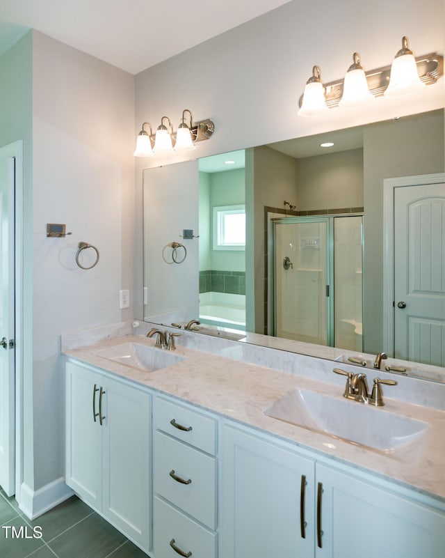 3206 Dandelion Dr, Grimesland, NC 27837 - bathroom featuring double vanity, a garden tub, a shower stall, and tile patterned floors
