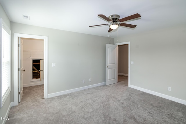 3206 Dandelion Dr, Grimesland, NC 27837 - unfurnished bedroom with a spacious closet, carpet, a closet, and ceiling fan