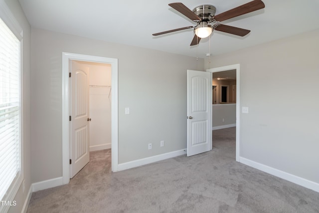 3206 Dandelion Dr, Grimesland, NC 27837 - unfurnished bedroom with a spacious closet, carpet, a closet, and a ceiling fan