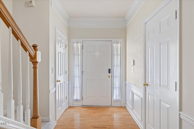 309 Ruby Walk Dr, Morrisville, NC 27560 - entrance foyer featuring stairway, light wood finished floors, ornamental molding, and a decorative wall