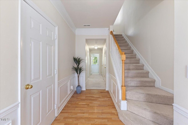 309 Ruby Walk Dr, Morrisville, NC 27560 - stairs with wood finished floors, crown molding, wainscoting, and a decorative wall