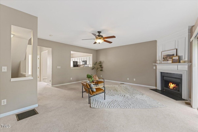 309 Ruby Walk Dr, Morrisville, NC 27560 - living room with light carpet, a ceiling fan, and a fireplace