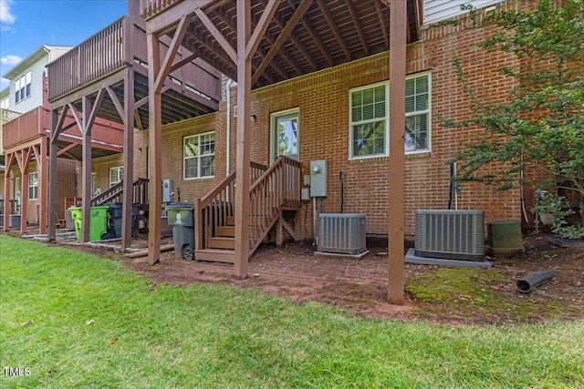 309 Ruby Walk Dr, Morrisville, NC 27560 - rear view of house with brick siding, a yard, and a deck