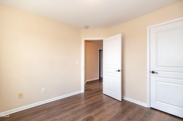 10119 Glen Autumn Rd, Raleigh, NC 27617 - unfurnished bedroom with dark wood-type flooring and baseboards