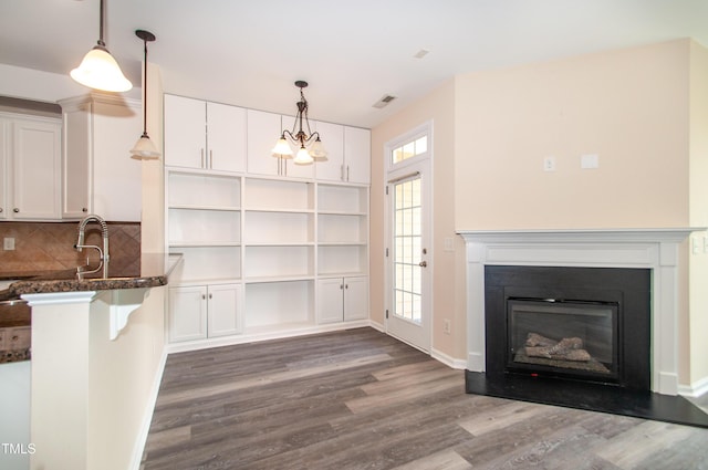 10119 Glen Autumn Rd, Raleigh, NC 27617 - kitchen featuring dark wood-type flooring, white cabinets, hanging light fixtures, and a breakfast bar area