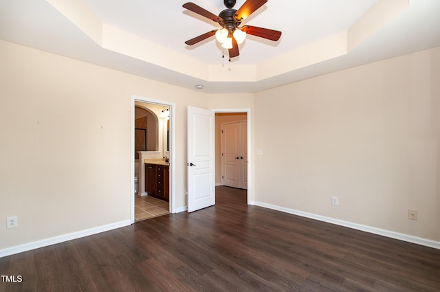 10119 Glen Autumn Rd, Raleigh, NC 27617 - empty room featuring a tray ceiling, ceiling fan, and dark wood-type flooring