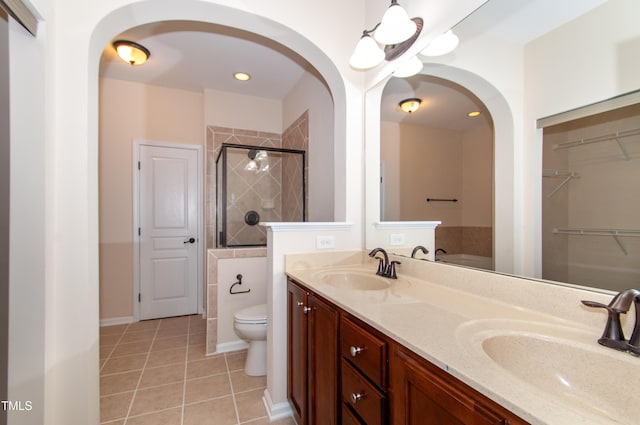 10119 Glen Autumn Rd, Raleigh, NC 27617 - full bath featuring tile patterned floors, a shower stall, double vanity, a spacious closet, and recessed lighting
