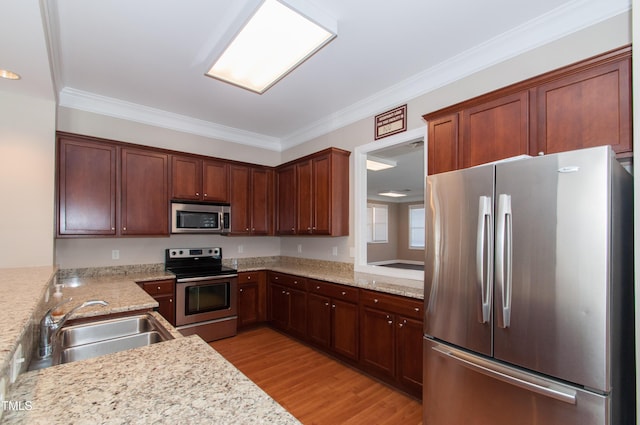 10119 Glen Autumn Rd, Raleigh, NC 27617 - kitchen featuring stainless steel appliances, light wood-type flooring, crown molding, and light stone countertops