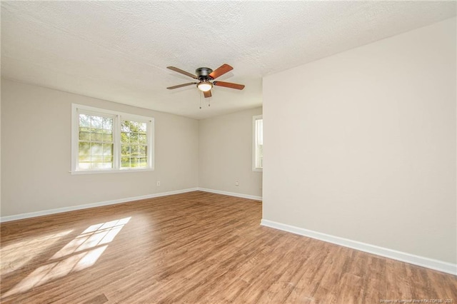 3211 Blossom Rd, Fayetteville, NC 28306 - unfurnished room with plenty of natural light, light wood finished floors, ceiling fan, and a textured ceiling