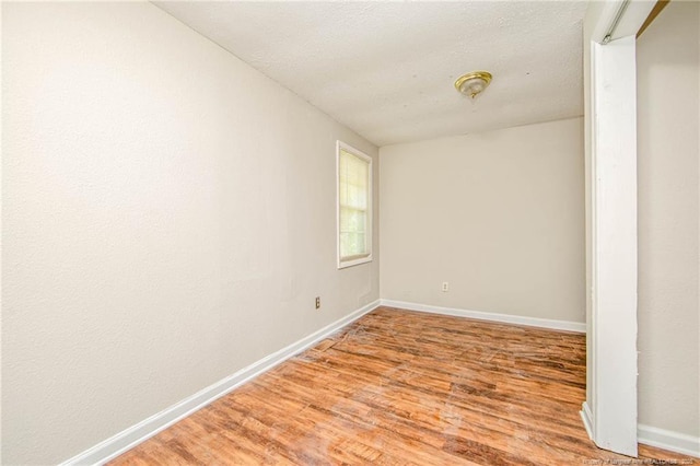 3211 Blossom Rd, Fayetteville, NC 28306 - empty room featuring light wood-style floors and a textured ceiling