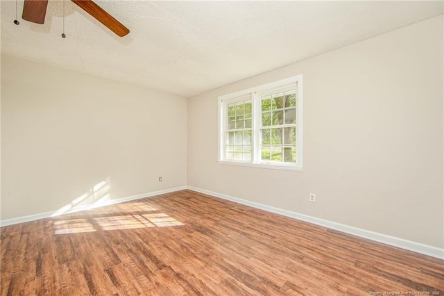 3211 Blossom Rd, Fayetteville, NC 28306 - empty room with wood finished floors, a ceiling fan, and a textured ceiling