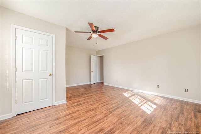 3211 Blossom Rd, Fayetteville, NC 28306 - unfurnished bedroom featuring light wood-style flooring, ceiling fan, and a textured ceiling