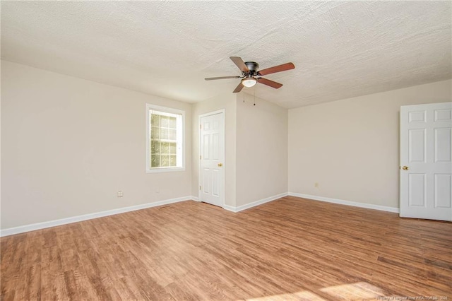 3211 Blossom Rd, Fayetteville, NC 28306 - empty room featuring light wood-style floors, a ceiling fan, and a textured ceiling