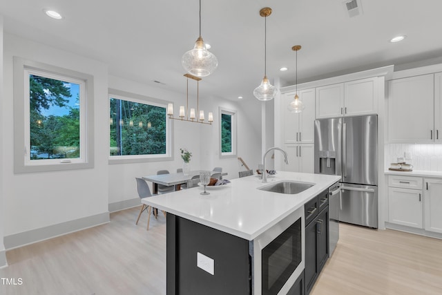 1000 Addison Pl Unit 101, Raleigh, NC 27610 - kitchen featuring appliances with stainless steel finishes, light countertops, healthy amount of natural light, and recessed lighting