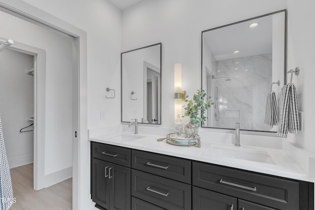 1000 Addison Pl Unit 101, Raleigh, NC 27610 - bathroom with a marble finish shower, double vanity, wood finished floors, recessed lighting, and a closet
