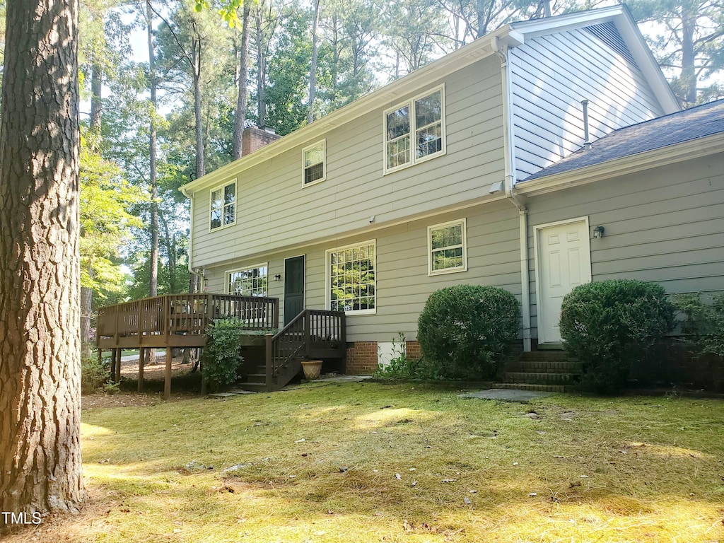 6115 Winthrop Dr, Raleigh, NC 27612 - back of house featuring a deck, a lawn, and a chimney