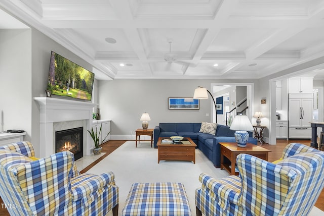 2153 Princeville Dr, Apex, NC 27523 - living area with wood finished floors, a high end fireplace, a ceiling fan, coffered ceiling, and beamed ceiling
