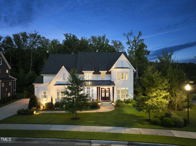 2153 Princeville Dr, Apex, NC 27523 - modern farmhouse featuring a standing seam roof, french doors, a front lawn, and board and batten siding