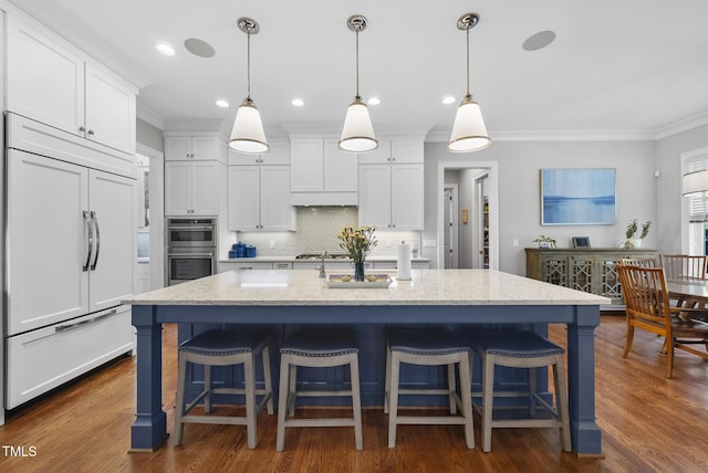 2153 Princeville Dr, Apex, NC 27523 - kitchen with paneled refrigerator, ornamental molding, white cabinetry, decorative backsplash, and gas cooktop