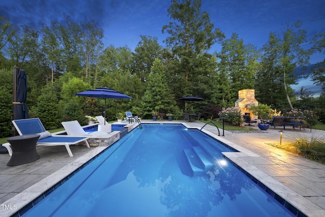 2153 Princeville Dr, Apex, NC 27523 - swimming pool with an outdoor stone fireplace and a patio