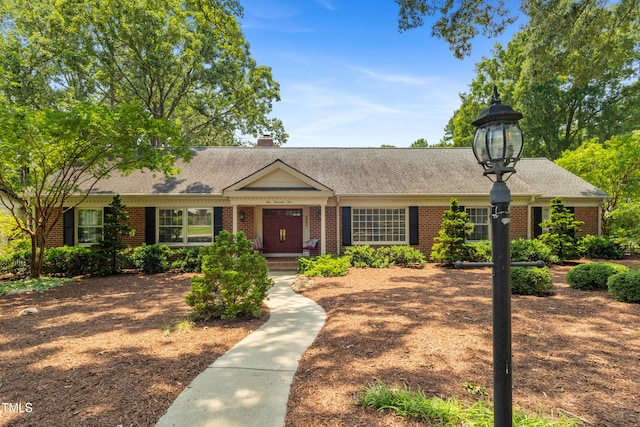 4009 Pepperton Dr, Raleigh, NC 27606 - view of front of home with brick siding, a shingled roof, and a chimney