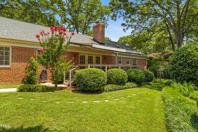 4009 Pepperton Dr, Raleigh, NC 27606 - back of house featuring brick siding, a chimney, and a wooden deck