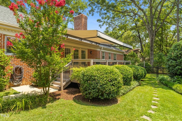 4009 Pepperton Dr, Raleigh, NC 27606 - back of house with brick siding, a chimney, a deck, and roof with shingles