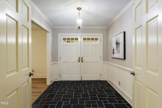 4009 Pepperton Dr, Raleigh, NC 27606 - entrance foyer with crown molding, a wainscoted wall, and a textured ceiling