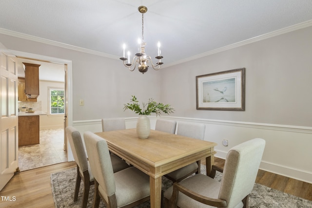 4009 Pepperton Dr, Raleigh, NC 27606 - dining space with a chandelier, light wood-type flooring, and crown molding