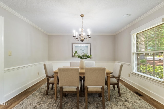 4009 Pepperton Dr, Raleigh, NC 27606 - dining space featuring a chandelier, healthy amount of natural light, dark wood-style flooring, and ornamental molding