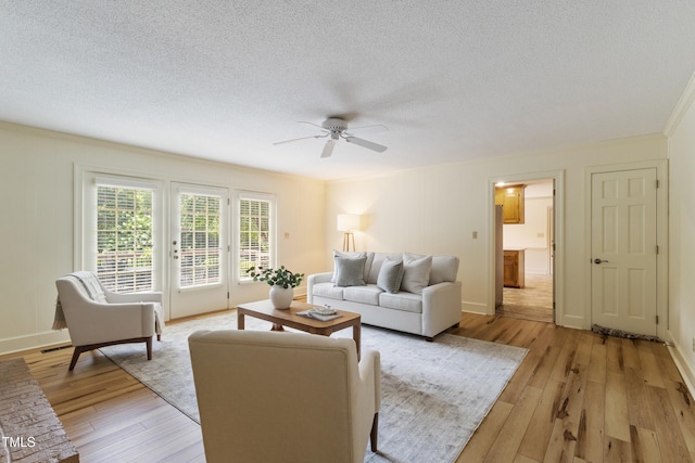 4009 Pepperton Dr, Raleigh, NC 27606 - living area featuring ceiling fan, light wood finished floors, a textured ceiling, and crown molding
