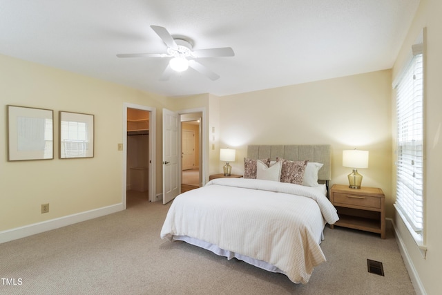 4009 Pepperton Dr, Raleigh, NC 27606 - bedroom featuring multiple windows, carpet flooring, ceiling fan, and a walk in closet