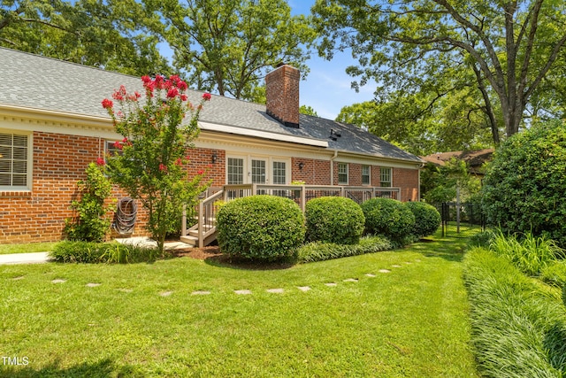 4009 Pepperton Dr, Raleigh, NC 27606 - rear view of house featuring a chimney, brick siding, and a deck