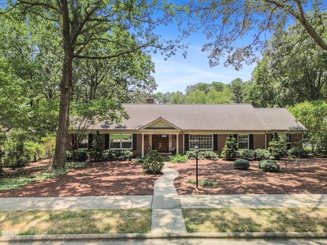4009 Pepperton Dr, Raleigh, NC 27606 - single story home with brick siding and a chimney