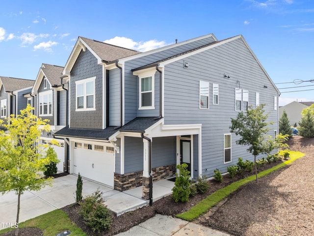 1315 Canary Pepper Dr Unit 28, Durham, NC 27713 - townhome / multi-family property with an attached garage, driveway, roof with shingles, and stone siding