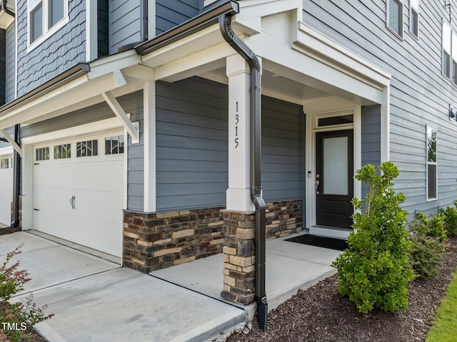 1315 Canary Pepper Dr Unit 28, Durham, NC 27713 - property entrance featuring an attached garage, covered porch, and stone siding
