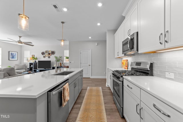 1315 Canary Pepper Dr Unit 28, Durham, NC 27713 - kitchen featuring appliances with stainless steel finishes, open floor plan, light countertops, backsplash, and recessed lighting
