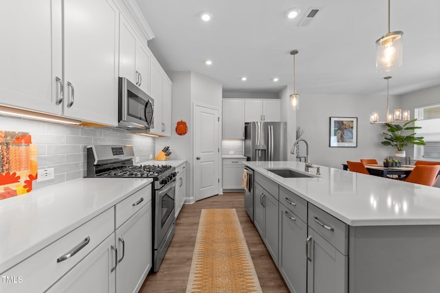 1315 Canary Pepper Dr Unit 28, Durham, NC 27713 - kitchen with stainless steel appliances, wood finished floors, light countertops, recessed lighting, and a chandelier