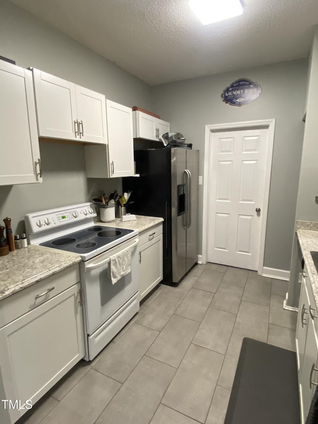 30 Bethany Ln, Youngsville, NC 27596 - kitchen with electric stove, stainless steel fridge with ice dispenser, white cabinetry, a textured ceiling, and light tile patterned floors
