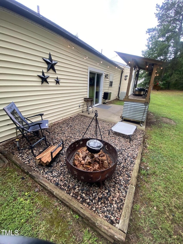 30 Bethany Ln, Youngsville, NC 27596 - rear view of property featuring an outdoor fire pit and a patio area
