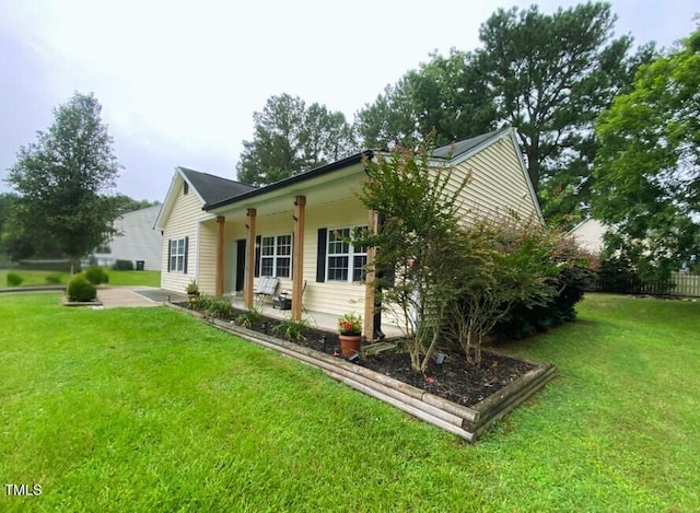 30 Bethany Ln, Youngsville, NC 27596 - view of property exterior featuring a yard and a patio area