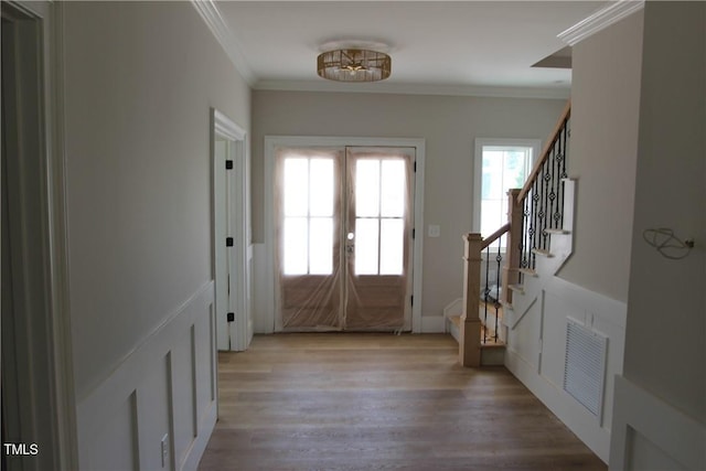 3501 Wesley Point Dr, Browns Summit, NC 27214 - entrance foyer featuring french doors, stairs, light wood finished floors, and ornamental molding