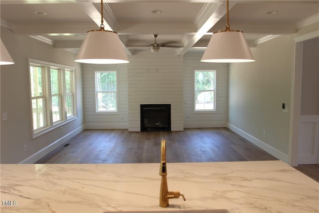 3501 Wesley Point Dr, Browns Summit, NC 27214 - unfurnished living room featuring wood finished floors, healthy amount of natural light, ornamental molding, a large fireplace, and beamed ceiling